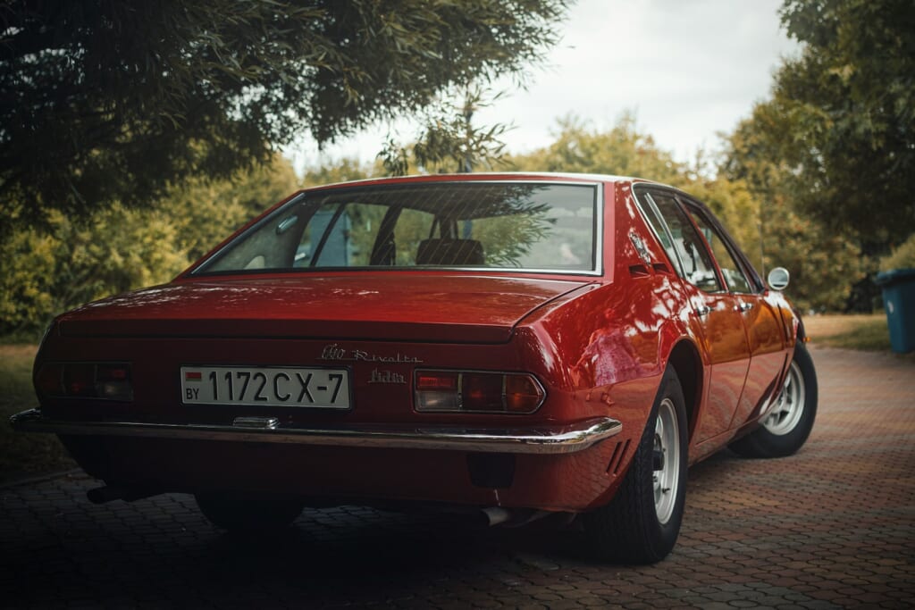 a red car parked on the side of a road