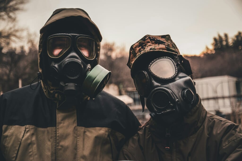 grayscale photo of person wearing gas mask