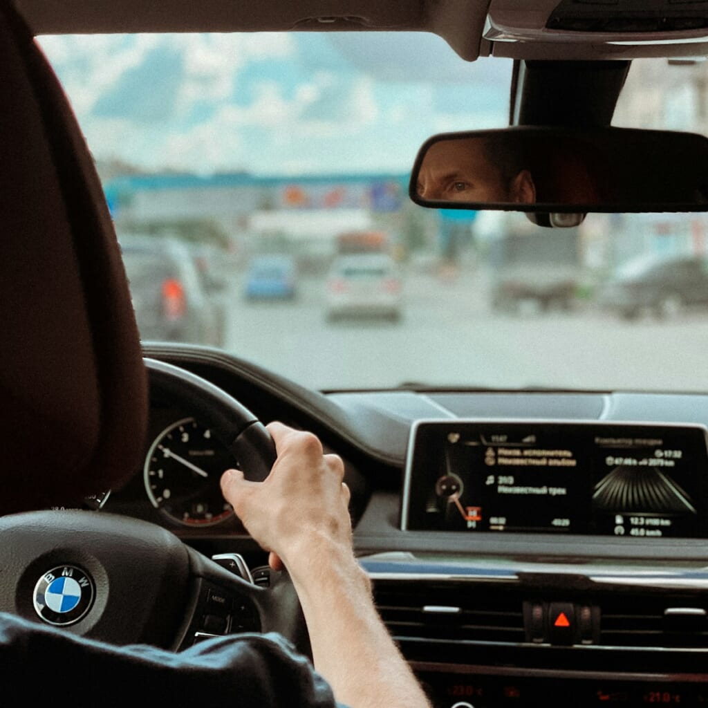 person driving car during daytime