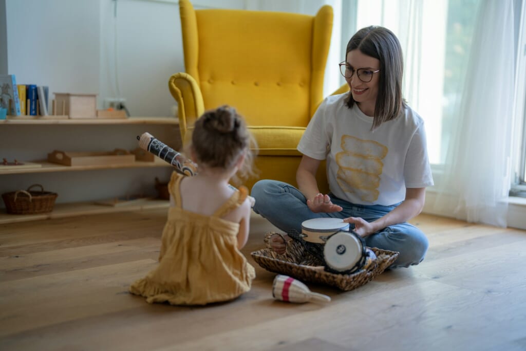 a person and a child sitting on the floor