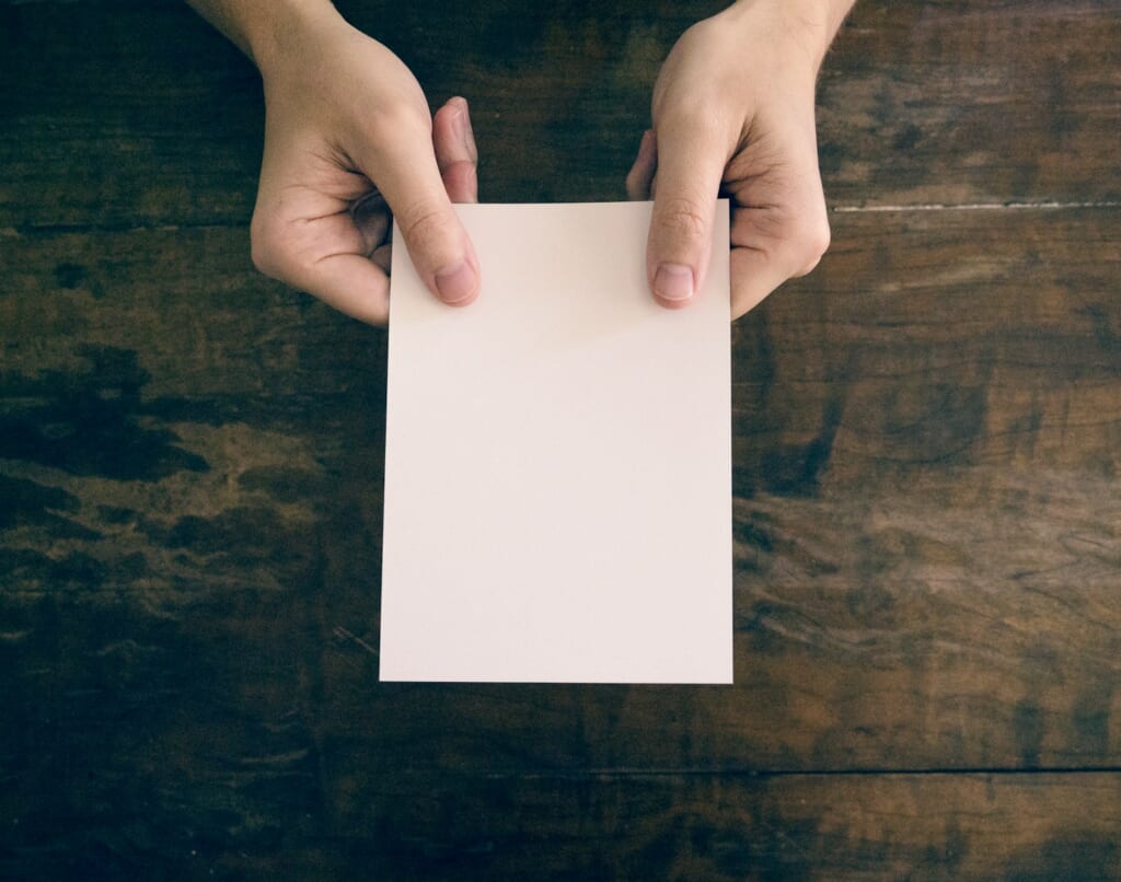 person holding white printer paper