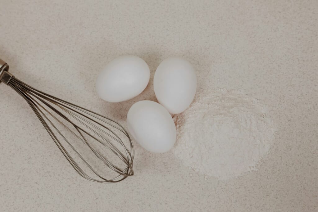 white egg on white sand