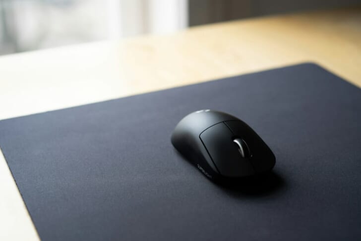 black cordless computer mouse on black surface