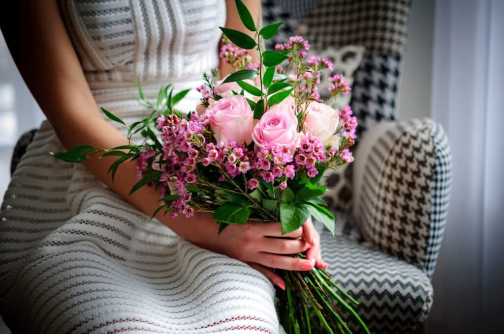 woman holding pink and white roses bouquet