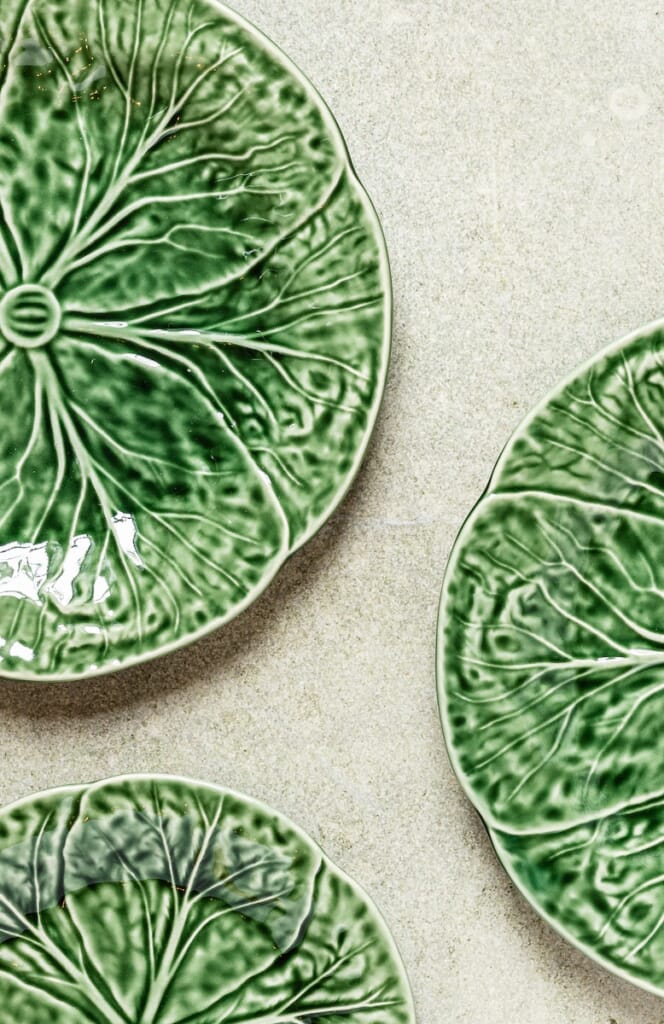 three green plates sitting on top of a table