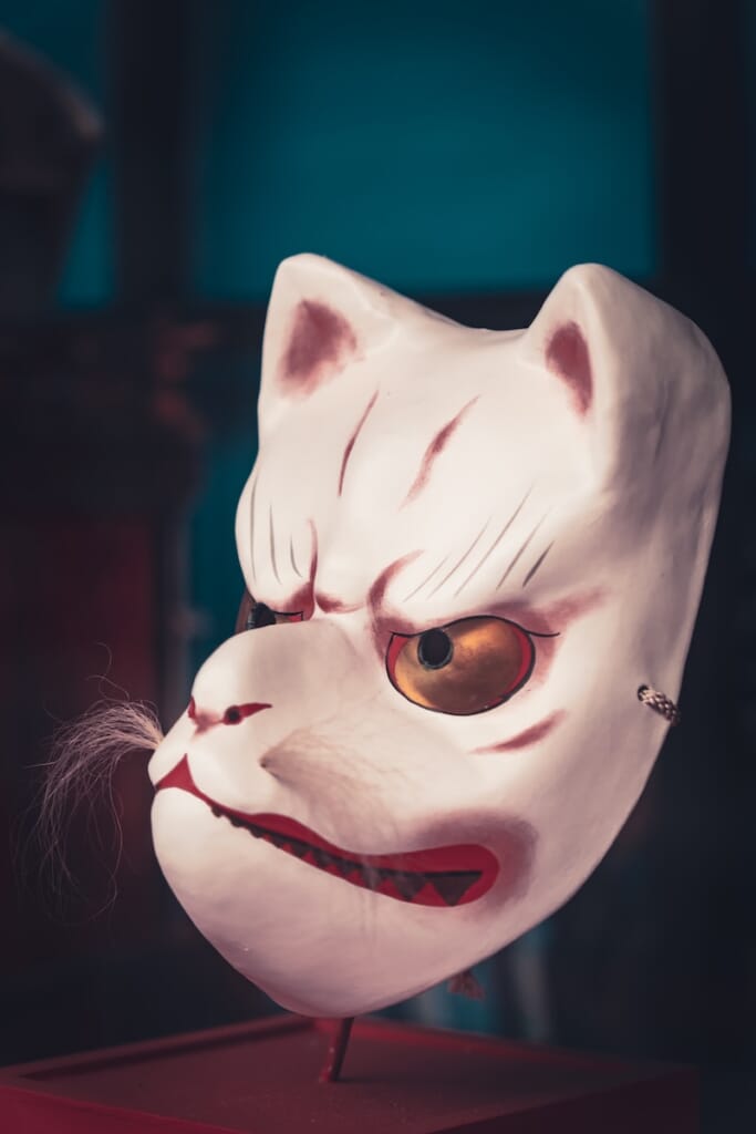 a white mask with a cat's head on top of it
