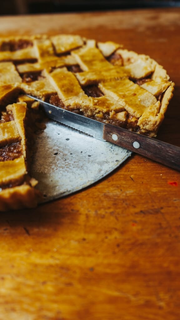 a close up of a pie on a table with a knife