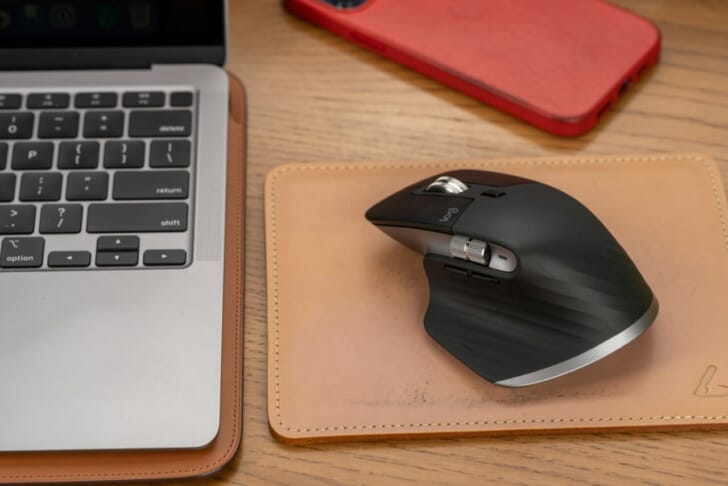 black cordless computer mouse on gray laptop computer